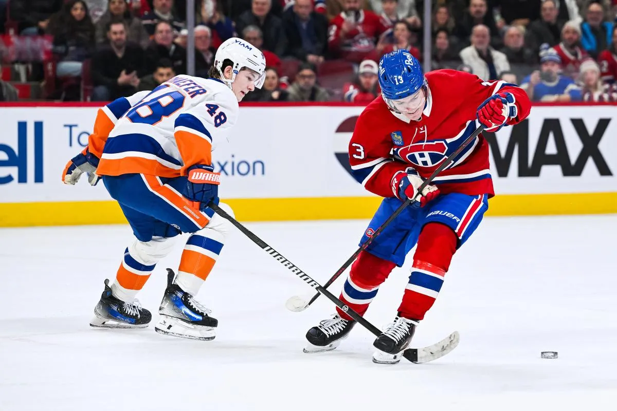 le d&eacute;fenseur des Islanders de New York, Matthew Schaefer (48), d&eacute;fend la rondelle face &agrave; l'ailier droit des Canadiens de Montr&eacute;al, Cole Caufield (13), en prolongation au Centre Bell.