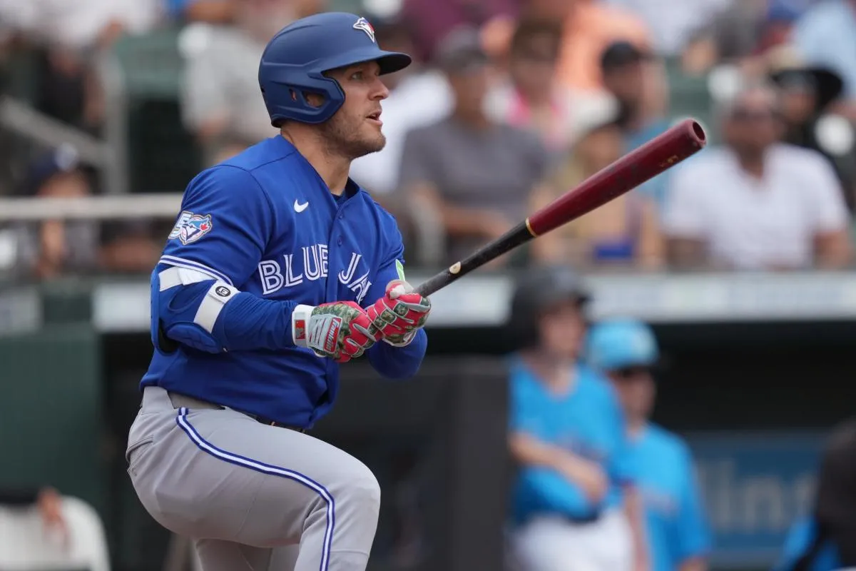 Toronto Blue Jays center fielder Daulton Varsho (5) hits a double that scores two runs in the third inning against the Miami Marlins at Roger Dean Chevrolet Stadium.