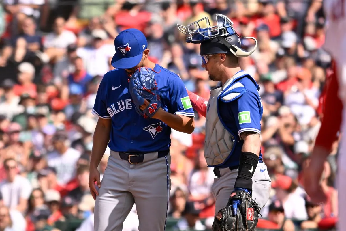 Toronto Blue Jays catcher Tyler Heineman (55) walk out to talk to relief pitcher Nick Sandlin (52) during the eighth inning against the Boston Red Sox at Fenway Park.