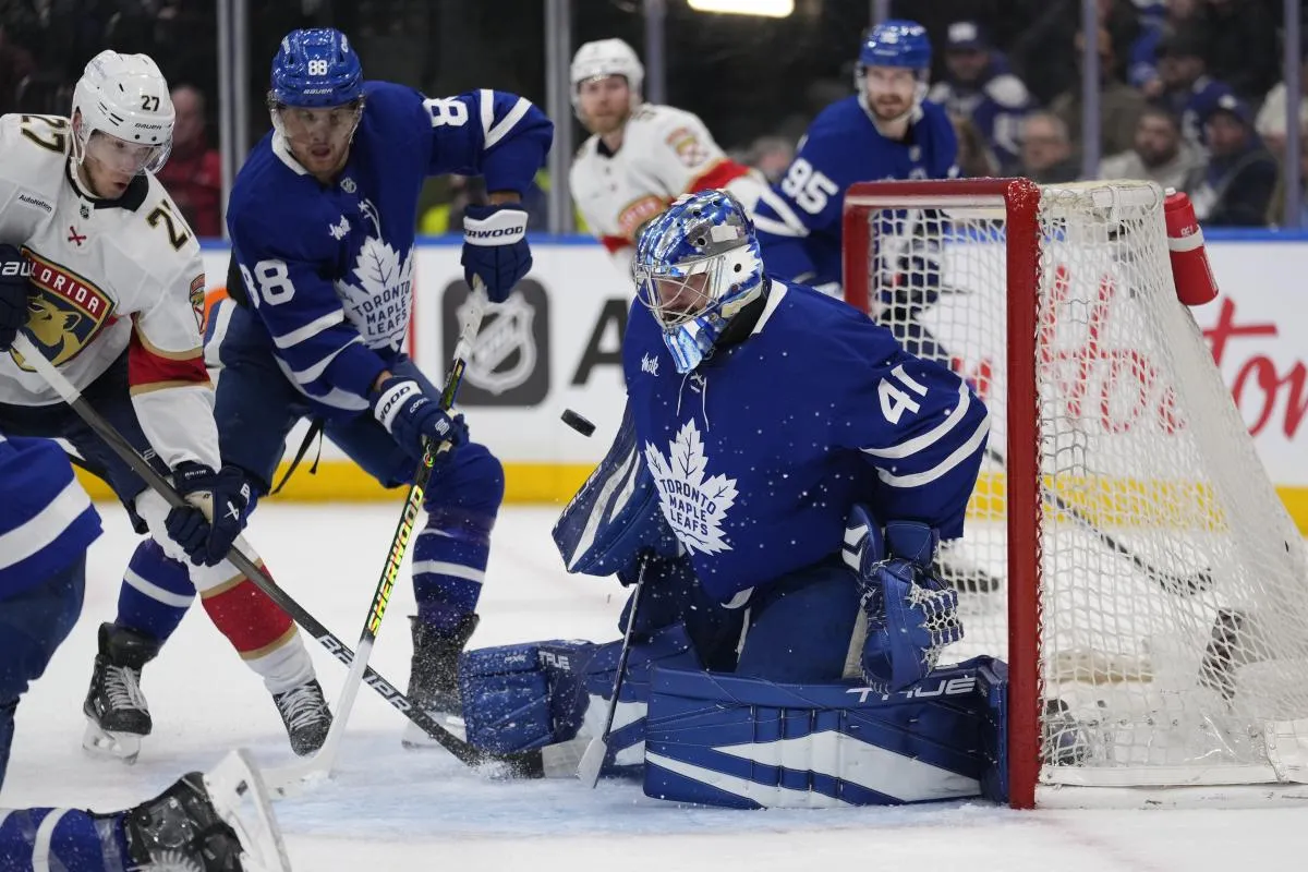Toronto Maple Leafs goaltender Anthony Stolarz (41) makes a save as forward William Nylander (88) and Florida Panthers forward Eetu Luostarinen (27) wait for a rebound during the second period at Scotiabank Arena.