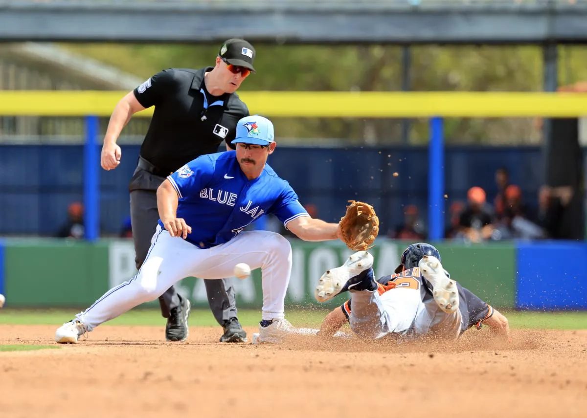 Detroit Tigers designated hitter Parker Meadows (22) steals second base as Toronto Blue Jays second baseman Davis Schneider (36) attempted to tag him out during the second inning at TD Ballpark.
