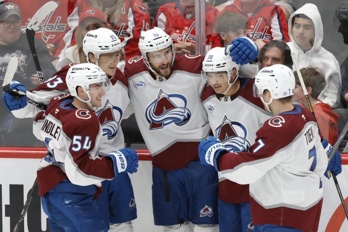 Colorado Avalanche center Nicolas Roy (10) celebrates with teammates after scoring a goal against the Washington Capitals during the third period at Capital One Arena.