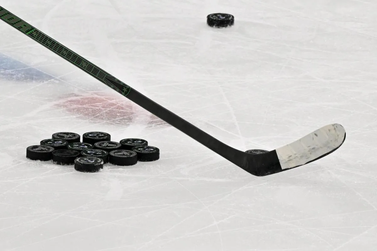 A view of a hockey stick and pucks before the game between the Dallas Stars and the Colorado Avalanche in game seven of the first round of the 2025 Stanley Cup Playoffs at American Airlines Center.