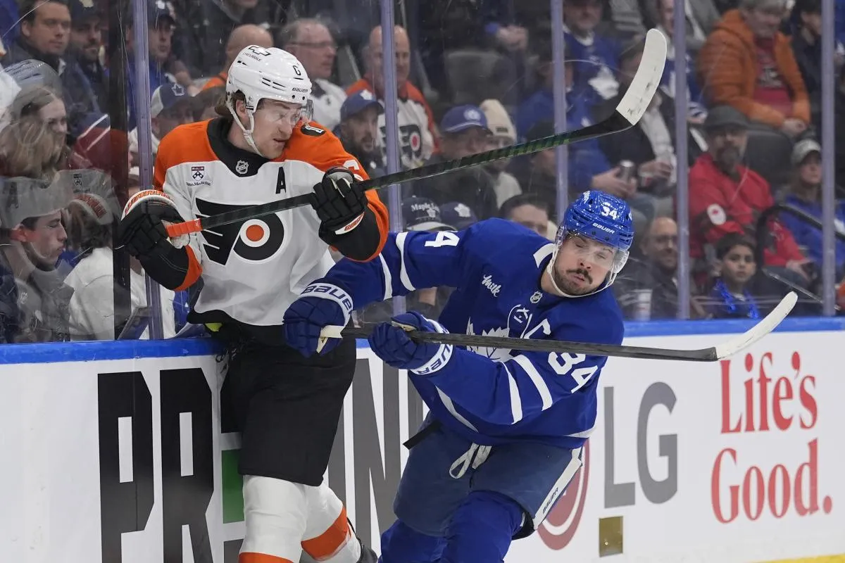 Toronto Maple Leafs forward Auston Matthews (34) checks Philadelphia Flyers defenseman Travis Sanheim (6) into the boards during the first period at Scotiabank Arena.