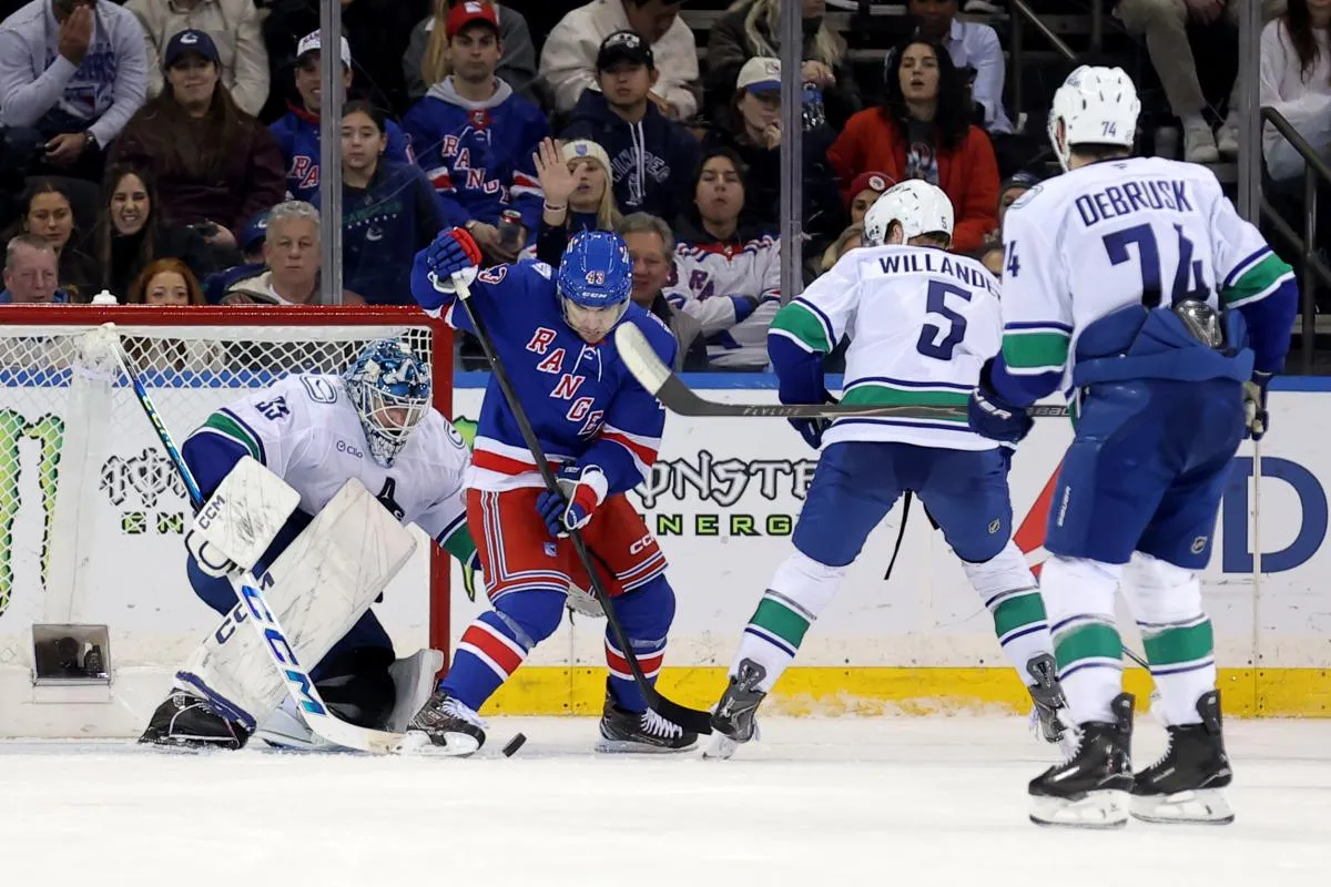 New York Rangers left wing Conor Sheary (43) plays the puck against Vancouver Canucks goaltender Thatcher Demko (35) and defenseman Tom Willander (5) during the third period at Madison Square Garden.