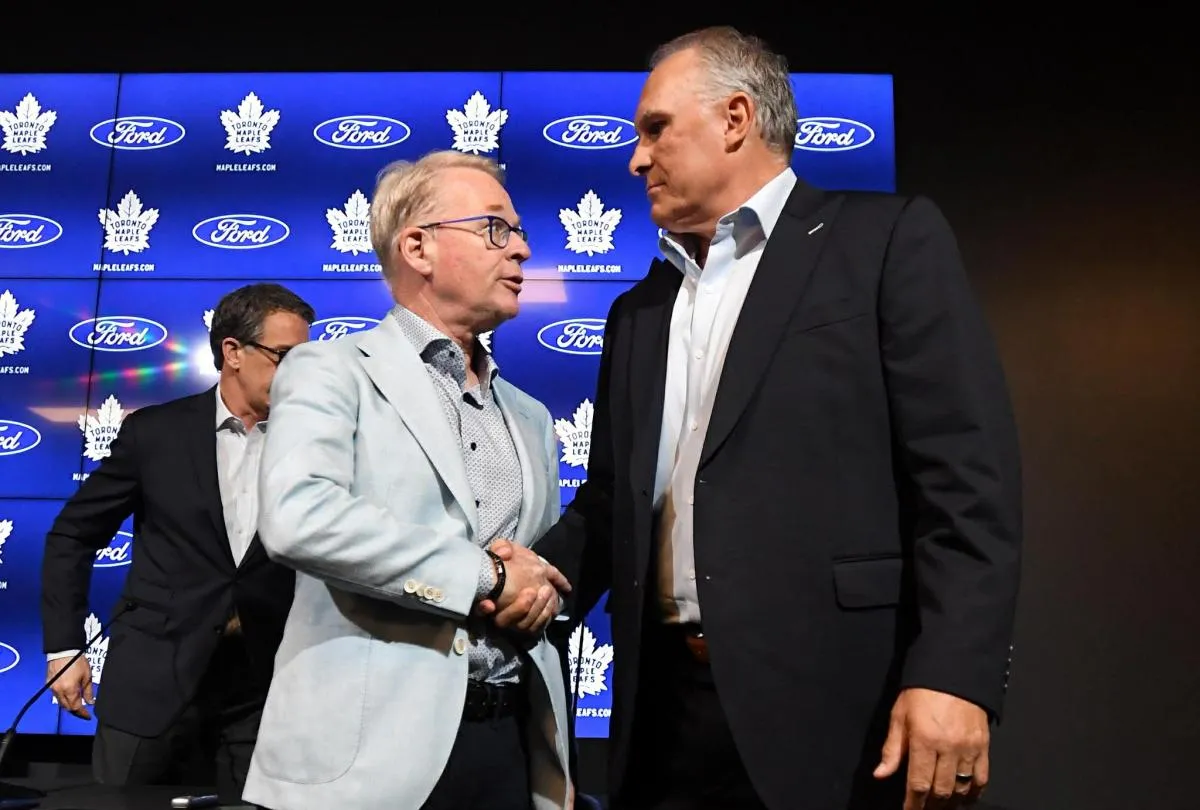 Maple Leaf Sport and Entertainment president Keith Pelley (left) shakes hands with newly appointed Toronto Maple Leafs head coach Craig Berube after an introductory media conference at Ford Performance Centre.