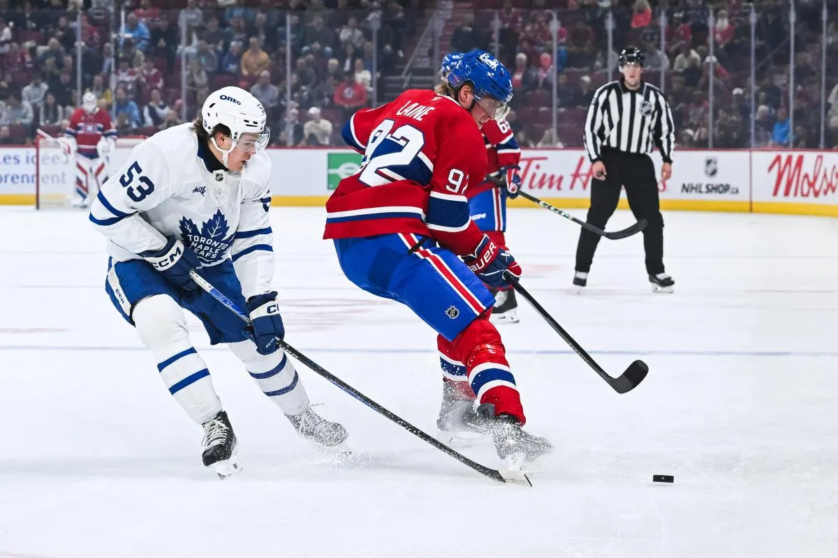 L'ailier droit des Canadiens de Montréal, Patrik Laine (92), s'empare de la rondelle avant l'attaquant des Maple Leafs de Toronto, Easton Cowan (53), au cours de la première période au Centre Bell.