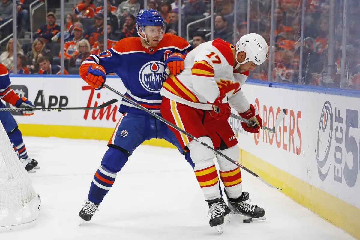 Edmonton Oilers forward Connor McDavid (97) and Calgary Flames forward Milan Lucic (17) battle along the boards for a loose puck during the second period at Rogers Place.