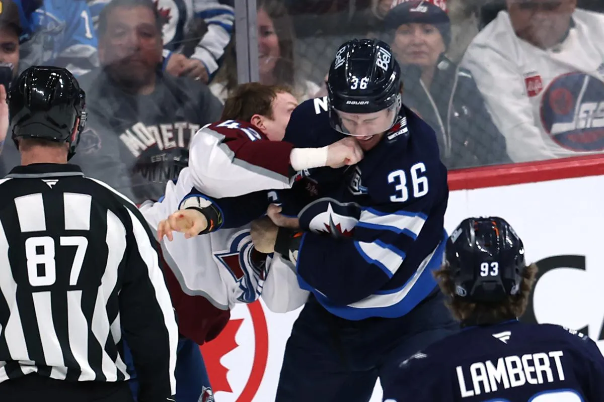 Colorado Avalanche defenseman Josh Manson (42) fights with Winnipeg Jets center Morgan Barron (36) in the third period at Canada Life Centre.