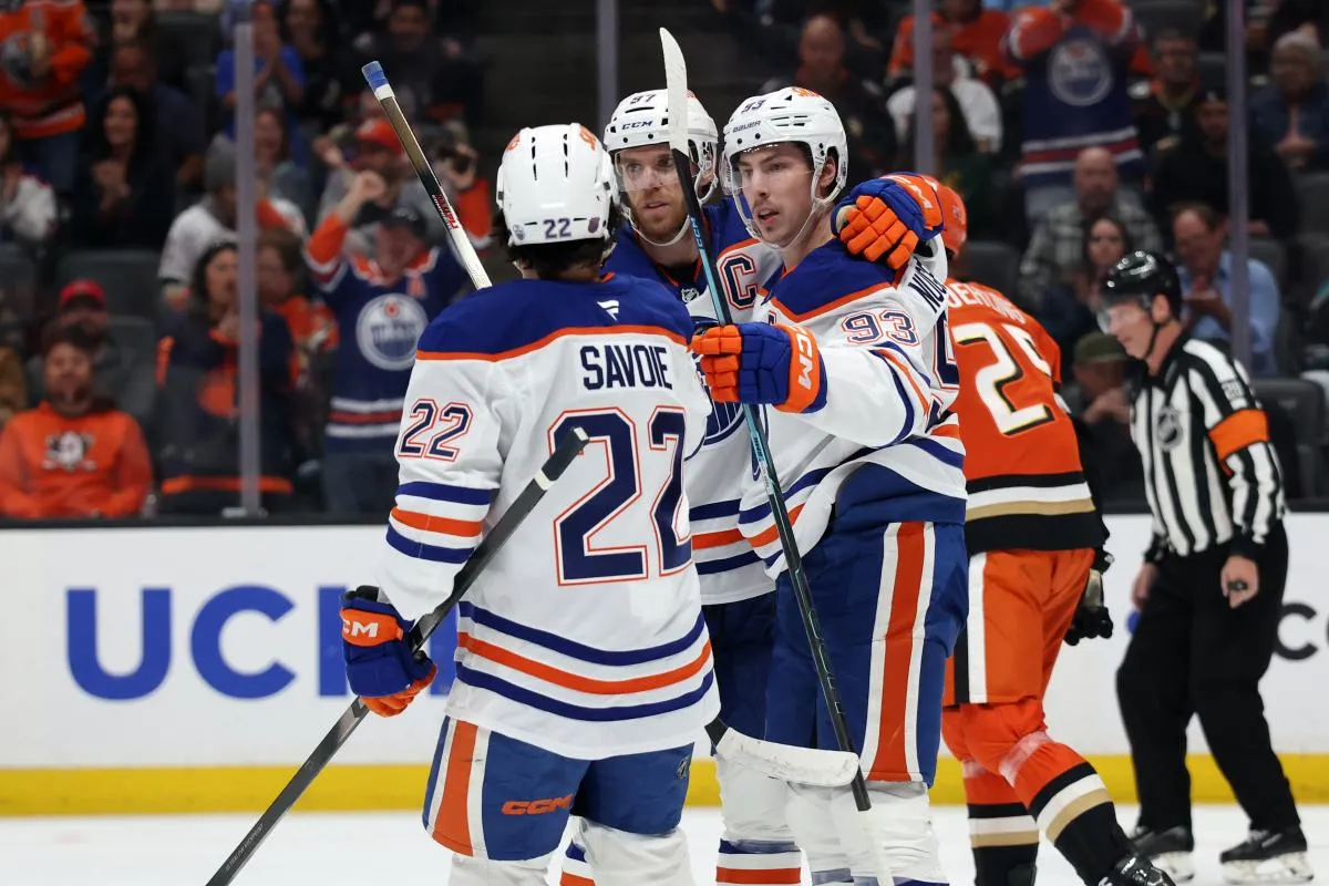 Edmonton Oilers center Ryan Nugent-Hopkins (93) celebrates with center Matt Savoie (22) and center Connor McDavid (middle) after scoring a goal during the first period against the Anaheim Ducks at Honda Center.