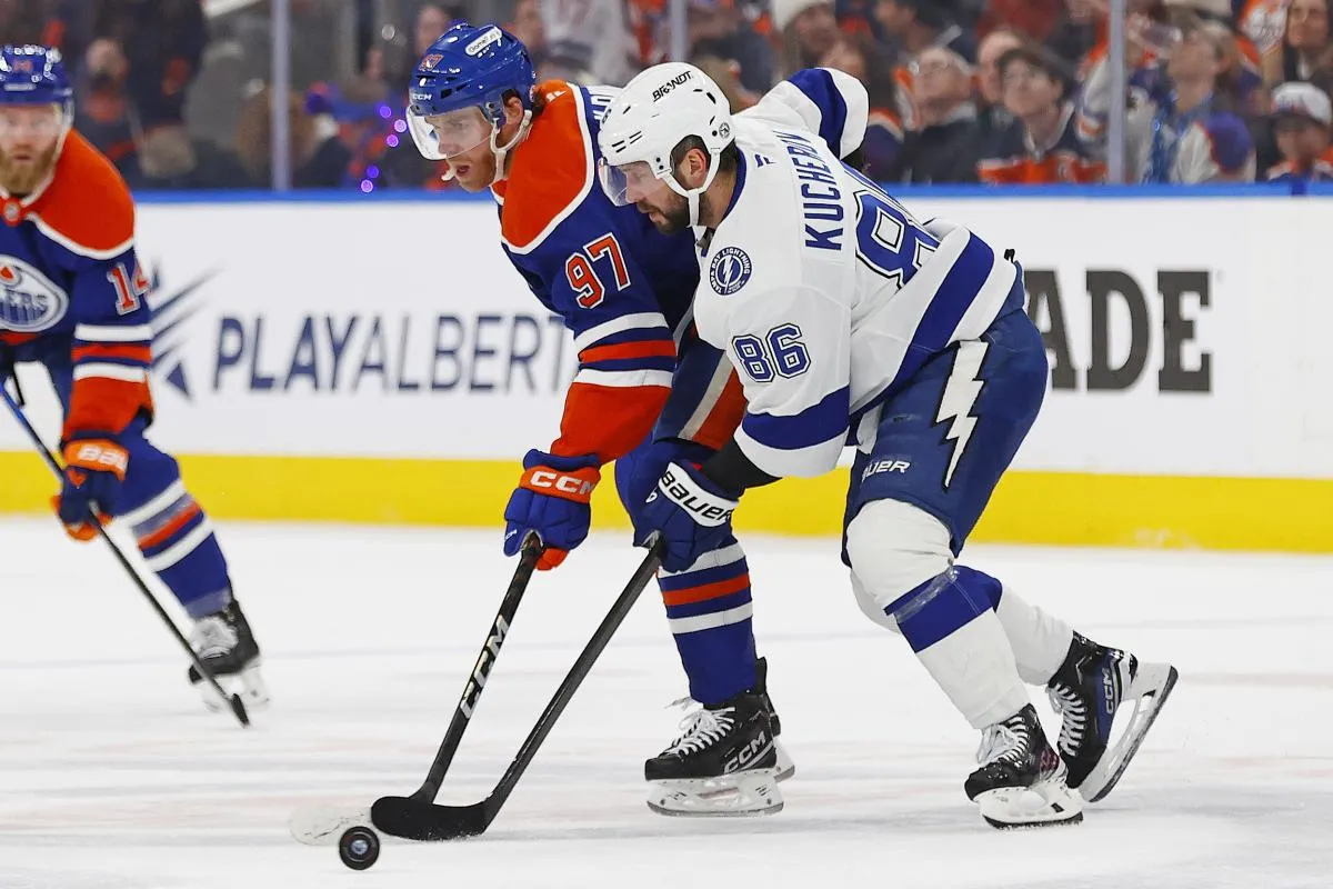 Tampa Bay Lightning forward Nikita Kucherov (86) and Edmonton Oilers forward Connor McDavid (97) battle for a loose puck during the first period at Rogers Place.