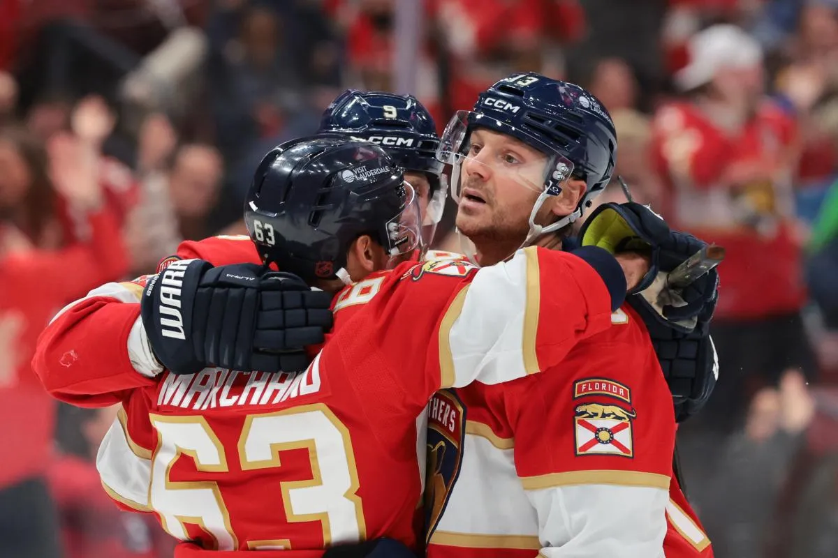 Florida Panthers center Sam Reinhart (13) celebrates with left wing Brad Marchand (63) and center Sam Bennett (9) after scoring against the St. Louis Blues during the second period at Amerant Bank Arena.