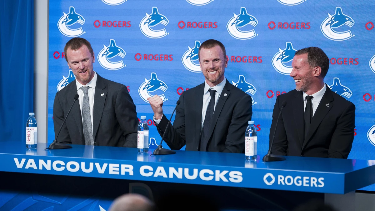The Vancouver Canucks promoted Henrik Sedin (left) and his twin brother Daniel Sedin (center) to co-presidents and Ryan Johnson (right) was named the Canucks new general manger during a press conference at Rogers Arena.