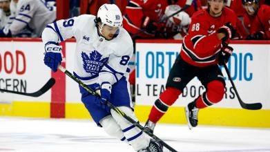 Nick Robertson carrying the puck in a road game against the Carolina Hurricanes.