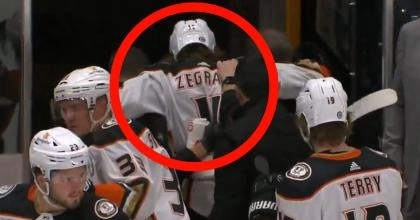 Anaheim Ducks forward Trevor Zegras being helped off the ice after suffering an injury against the Nashville Predators
