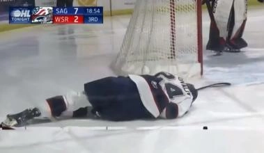 Maytas Sapovaliv, Vegas Golden Knights prospect and player for the Saginaw Spirit laying motionless on the ice after a dangerous collision into the boards.