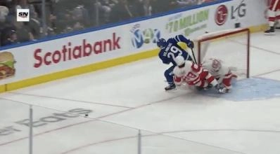Red Wings forward Patrick Kane tangled up with Maple Leafs forward Pontus Holmberg.
