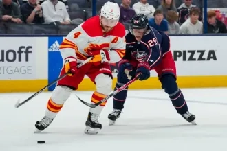 Calgary Flames Rasmus Andersson and Columbus Blue Jackets Patrik Laine during a game.
