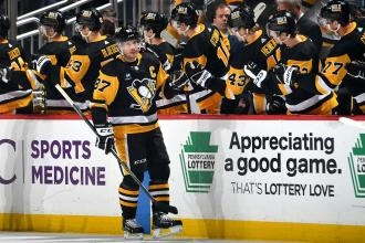 Penguins Captain Sidney Crosby gets high-fives from the bench after scoring