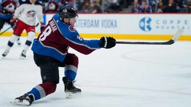 Colorado Avalanche defenseman Cale Makar taking a shot attempt