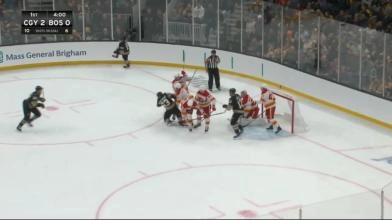 Flames forward Martin Pospisil taking a big swing at Bruins captain Brad Marchand.