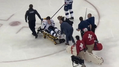 Mikhail Sergachev of the Tampa Bay Lightning is stretchered off the ice after a hit