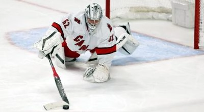 Carolina Hurricanes goaltender Pyotr Kochetkov making a diving poke check on a loose puck