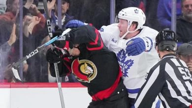 Toronto Maple Leafs Defenseman Morgan Rielly cross-checking Ottawa Senators Forward Ridly Greig