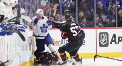 Toronto Maple Leafs defenseman Morgan Rielly cross-checking Ottawa Senators forward Ridly Greig