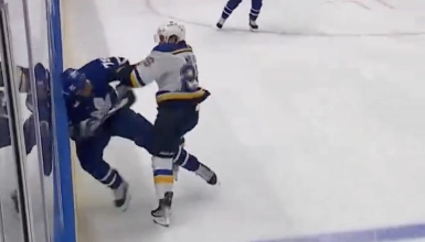 Toronto Maple Leafs veteran Ryan Reaves being hit by St. Louis Blues forward Nathan Walker