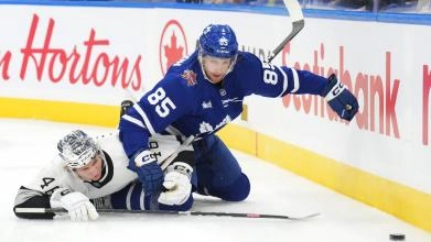 Maple Leafs defenseman William Lagesson in a puck battle.