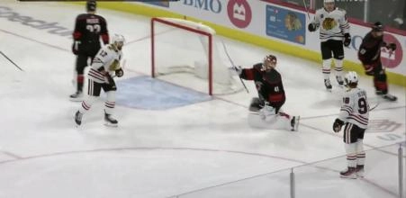 Blackhawks forward Connor Bedard staring down Hurricanes goalie Spencer Martin.