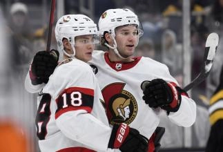 Ottawa Senators forwards Josh Norris and Tim Stutzle celebrating a goal