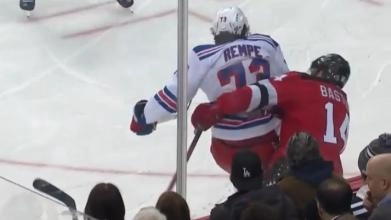New York Rangers' player Matthew Rempe landing a dirty hit on New Jersey Devils' Nathan Bastian in a game.