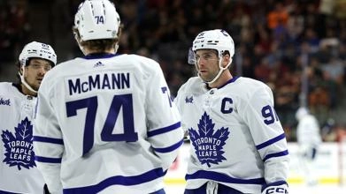 John Tavares, Bobby McMann, and Nick Robertson on the ice for the Toronto Maple Leafs.