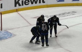 Maple Leafs defenseman Simon Benoit being helped off the ice by teammates after an injury. Maple Leafs defenseman Simon Benoit being helped off the ice by teammates after an injury.