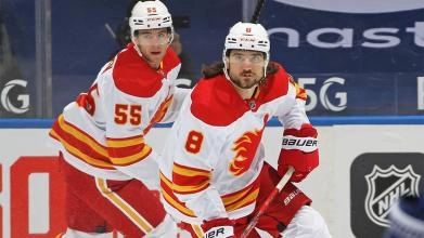 Chris Tanev and Noah Hanifin in a game with the Calgary Flames