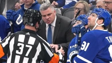 Toronto Maple Leafs head coach Sheldon Keefe yelling in an official's face.