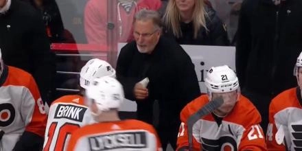 Philadelphia Flyers head coach John Tortorella lashing out on Bobby Brink at the bench during a game.