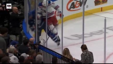 New York Rangers forward Matt Rempe hitting Toronto Maple Leafs defenseman Ilya Lyubushkin into the boards.