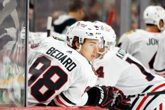Connor Bedard at the Chicago Blackhawks bench during a game.