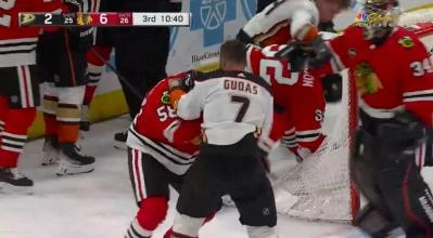 Blackhawks and Ducks players battling in a scrum