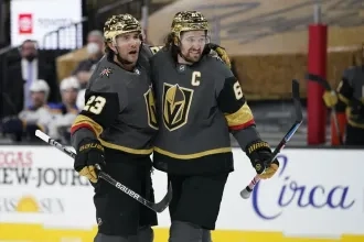 Vegas Golden Knights right wing Mark Stone, right, celebrates after defenseman Alec Martinez, left, scored a goal against St. Louis Blues during the second period of an NHL hockey game Friday, May 7