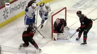 Toronto Maple Leafs captain John Tavares with his hands up in the air after having his stick broken by a slash from Carolina Hurricanes defenseman Jaccob Slavin.