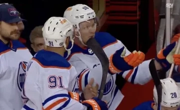 Evander Kane and Corey Perry of the Edmonton Oilers argue on the bench.
