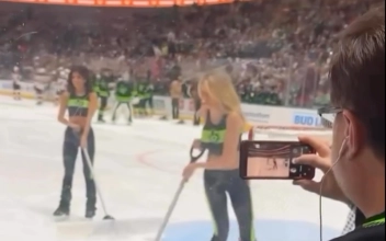 An unidentified fan photographing the Dallas Stars ice crew