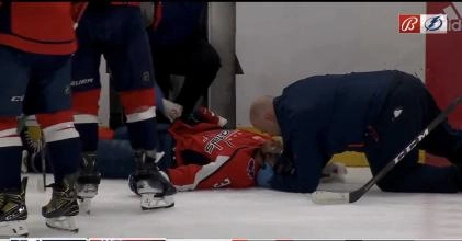 Washington Capitals defenseman Nick Jensen being attended to by medical personnel after taking a big hit from Michael Eyssimont.