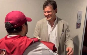 Arizona Coyotes' legend Shane Doan receiving his retirement banner from a fan.