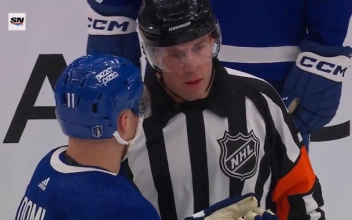 Max Domi talking to an official