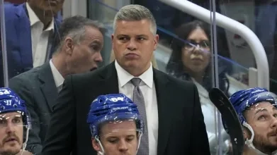 Toronto Maple Leafs head coach Sheldon Keefe skating with the players at a team practice